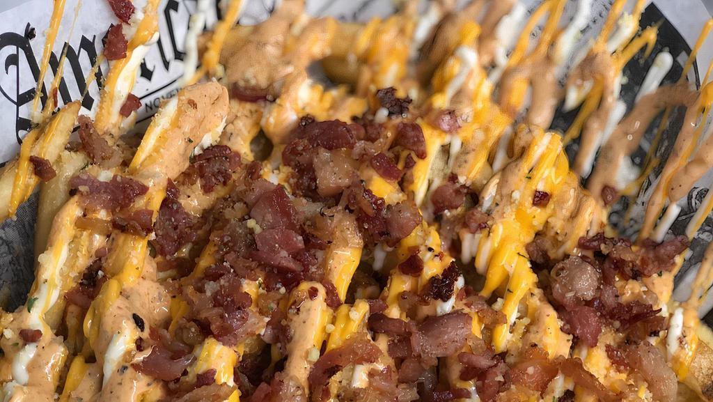 Bacon And Cheese Loaded Fries · French fries topped with crispy bacon, American cheese, and drizzled with creamy chipotle ranch.