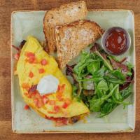 The Works Omelet · Ham, bacon, sausage, house-roasted crimini mushrooms, onions, and tomatoes with cheddar and ...