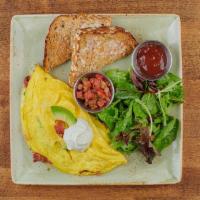 Bacado Omelet · Bacon, avocado, and Monterey Jack. Topped with sour cream and served with a side of housemad...