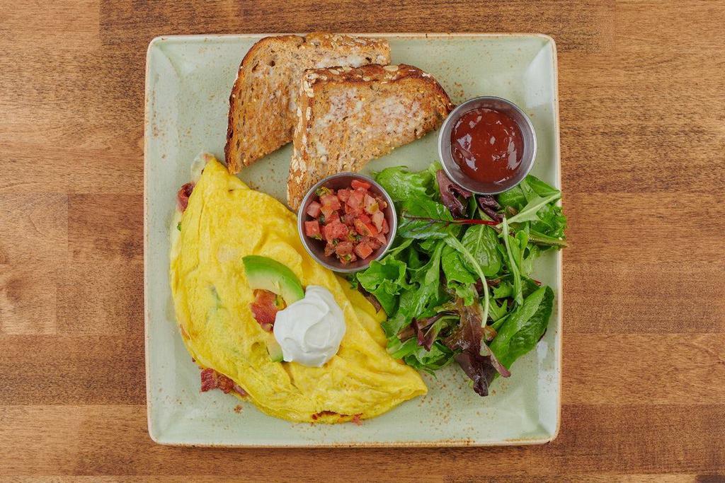 Bacado Omelet · Bacon, avocado, and Monterey Jack. Topped with sour cream and served with a side of housemade pico de gallo.