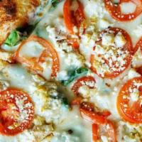 Tomato & Basil Pizza · Tomato and basil white pizza with garlic.
