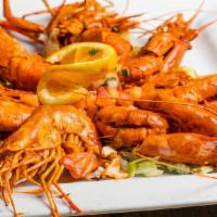 Langostinos · Jumbo prawns marinated in our homemade spicy seafood sauce served on a bed of lettuce and pi...
