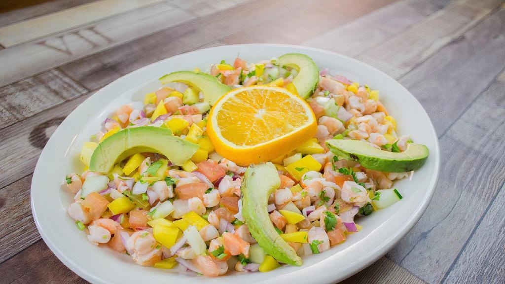 Ceviche Mazatlán * · Raw shrimp or fish marinated in lime juice , mixed with tomato , chopped onions , cilantro , cucumber , mango and avocado .