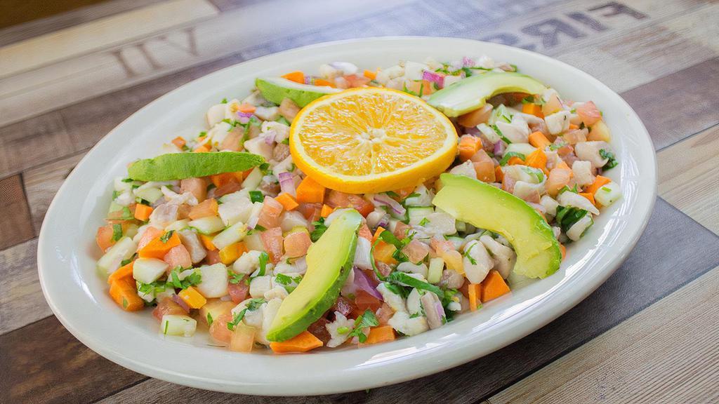 Ceviche Nayarit * · Fish marinated in lime juice , mixed with tomato , chopped onions , cilantro , cucumber , carrot and avocado .