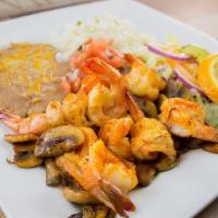 Camarones Con Hongos · Large prawns sautéed with garlic butter , mushrooms , covered with mojo de ajo sauce served ...