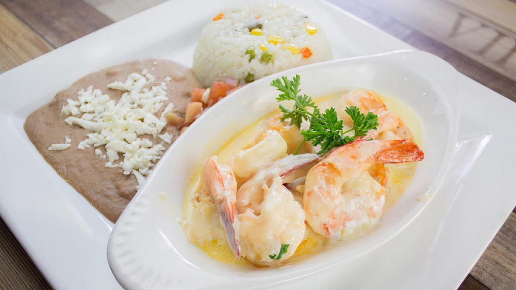 Camarones Gratinados · Large mexican prawns cooked in our seafood creamy sauce served with rice , beans and pico de gallo .