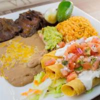 Tapatio * · Steak and taquitos dorados served with rice , beans , guacamole , onion and jalapeño .