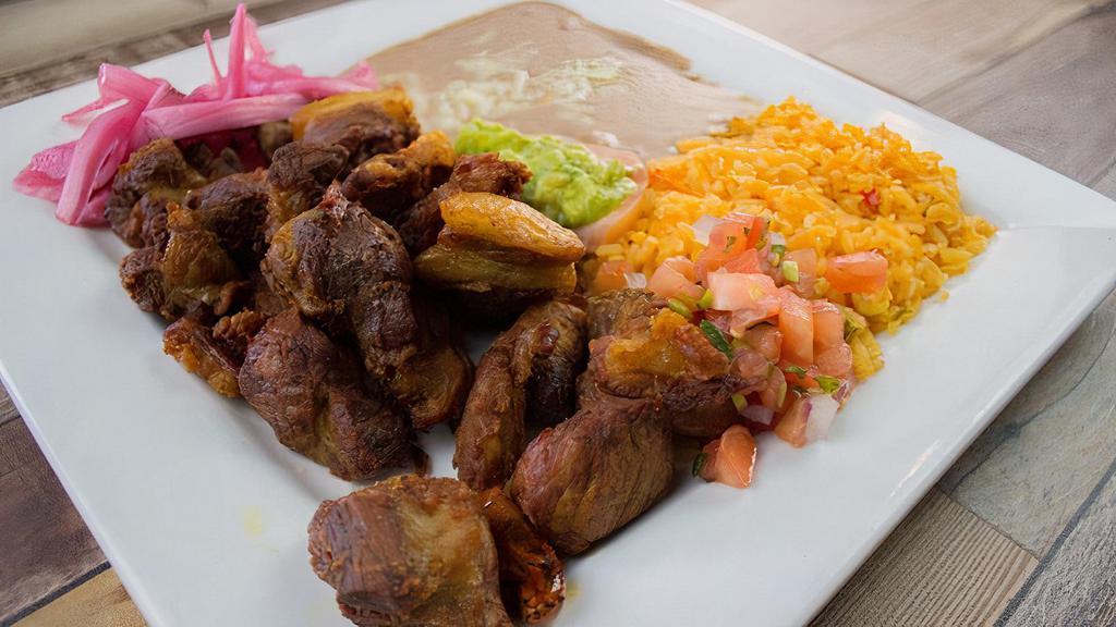 Pork Carnitas · Traditional mexican carnitas served with rice and beans , guacamole , sour cream and pico de gallo .