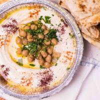 Classic Hummus Bowl · Dressed with freshly squeezed lemon juice, imported olive oil, parsley, and sumac spice. Ser...
