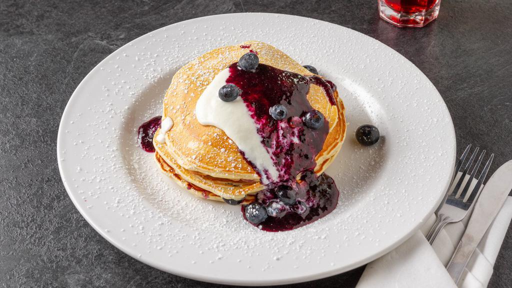 Lemon Ricotta Blueberry Pancakes · Wake up in style with three of our mouthwatering signature fluffy pancakes, with fresh blueberries, lemon ricotta cheese, our blueberry compote and 100% pure maple syrup.