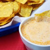 Chips Con Choriqueso · Chorizo mix with queso dip. Served with tortilla chips.
