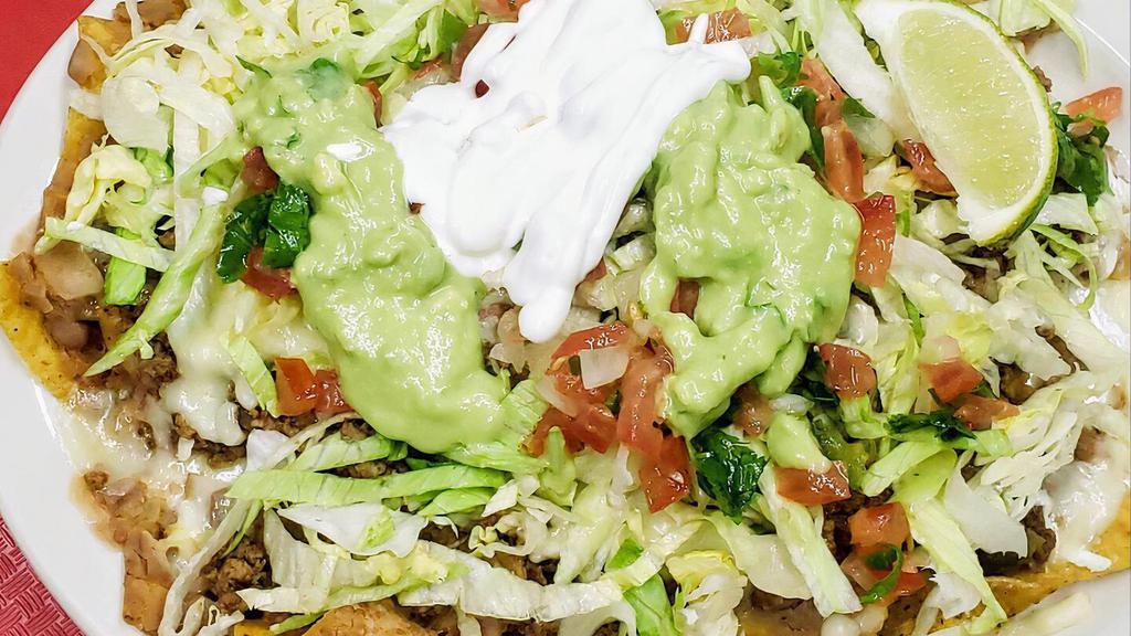 Nachos Supreme · choose chicken or beef, covered with refried beans, cheese, lettuce, sour cream, pico de gallo and guacamole.