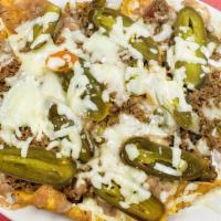 Nachos Texanos · Choose chicken or beef, covered with beans, cheese, and sliced jalapeños on corn tortilla ch...
