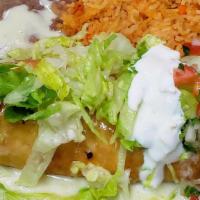 Chicken Chimichanga · Fried burrito topped with queso, lettuce, sour cream, pico de gallo and guacamole served wit...