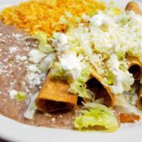 Tacos Dorados Combo · Four rolled and fried crunchy tacos with hot sauce, lettuce, cheese and sour cream on top. S...