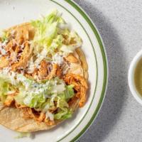 Chicken Taco · shredded chicken in guajillo sauce on a soft shell tortilla, topped with lettuce and cheese....