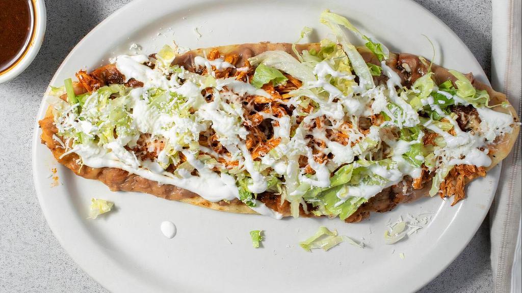One Huarache · A popular mexican dish consisting of a masa dough base smashed with pinto beans, your choice of meat, smoky chipotle sauce, lettuce, sour cream, and cheese. One of our most popular dishes.