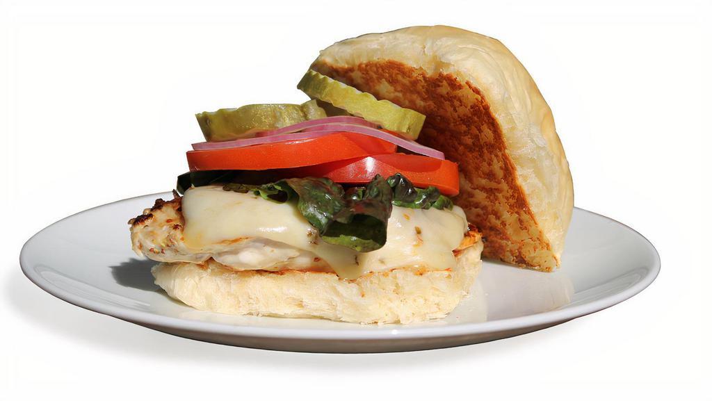 Grilled Chicken Sandwich · Juicy marinated  grilled chicken breast with a fresh griddled Breadworks brioche bun.  Choice of Cheddar, Swiss, Pepper Jack or American cheese.  Fresh sliced tomato and red onion, dill pickle,  and red leaf lettuce on the side.