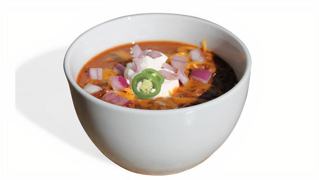 Housemade Chili · Whole tomatoes cooked down with onions, peppers, garlic, jalapenos with fresh ground beef and 3 kinds of beans.  Grated Cheddar, sour cream, diced onions and crackers on the side.