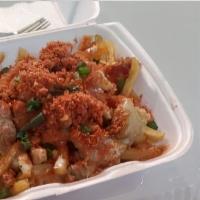 Cajun Crack Fries · Fries topped with chicken cracklin, applewood smoked bacon, drizzle of ranch, and topped wit...