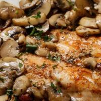 Broiled Tilapia  · Topped with mushrooms, and garlic in lemon butter sauce