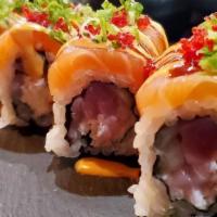 Naomi · Hamachi, tuna, crab salad and cucumber; topped with torched salmon, red tobiko, scallions, s...