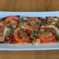 Margherita Flatbread · Crispy flatbread, Spanish tomato sauce, roma tomatoes, mozzarella cheese, oregano