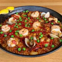 Paella Mixta · Valencia style rice, calamari, clams, shrimp, chorizo, chicken, sofrito, saffron