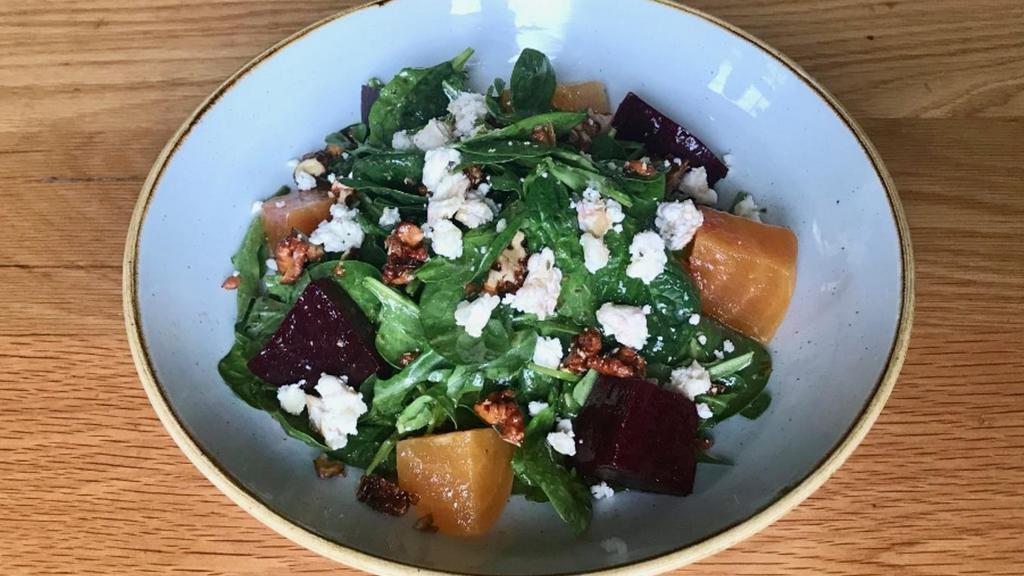 Spinach Salad · Baby spinach, golden and red beets, caramelized walnuts, arugula, goat cheese, basil ginger vinaigrette
