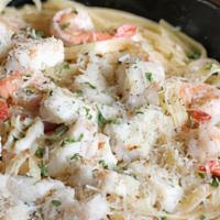 Seafood Alfredo · Fettuccine pasta topped with a combination of seafood mix baked with homemade creamy alfredo...