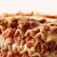 Meat Lasagna · Layers of baked lasagna loaded with beef, Parmesan, mozzarella and ricotta cheese. Topped wi...