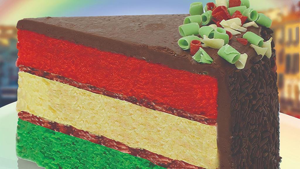 Rainbow Cake · Three colorful sponge cake layers are filled with sweet raspberry jam and almond marzipan topped with decadent chocolate icing, chocolate sprinkles and Italian colored blossom curls.