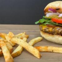 Dare Ya · Grass-fed beef patty topped with crisp bacon, yellow Cheddar cheese, spring mix lettuce, tom...