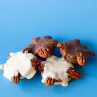 Pecan Paw · Pecans placed unto your choice of milk or white chocolate containing caramel on the inside.