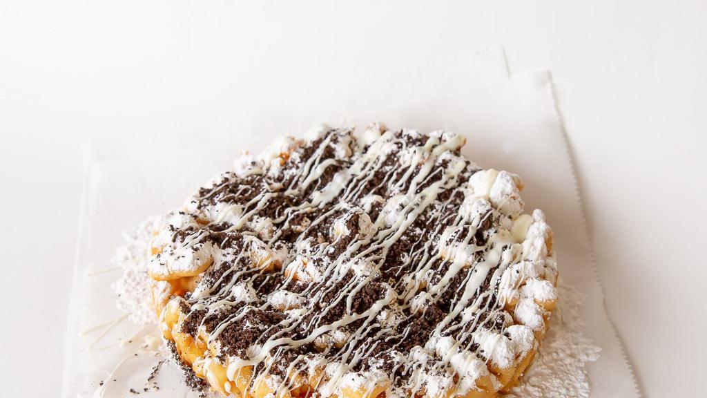 Cookies & Cream Funnel Cake · Your favorite fair food with a sprinkle of powdered sugar. This funnel cake is topped with chopped Oreos and a white chocolate drizzle to finish.