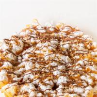Turtle Funnel Cake · Your favorite fair food with a sprinkle of powdered sugar. This funnel cake is topped with o...