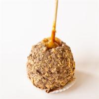 Heath Bar Apple · A classic granny smith apple dipped in caramel sauce, dipped in chocolate rolled Heath Bar