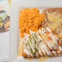 Chimichanga Texana · Two flour tortillas fried or soft filled with grilled chicken or steak fajitas, onons, tomat...