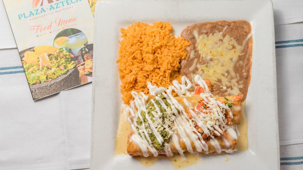Chimichanga Texana · Two flour tortillas fried or soft stuffed with steak or chicken fajitas, onions tomatoes and bell peppers. Topped with guacamole, sour cream, queso fresco and pico de gallo. Served with rice and beans