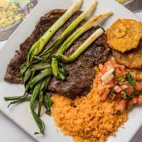 Churrasco Steak · Grilled Chimichurri Steak topped with grilled onions. Served with a side of tostones, pico d...