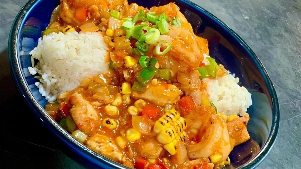 Shrimp & Chicken Creole · Cajun seasoned Chicken breast and shrimp smothered in a house made Creole sauce and served over white rice.  Garnished with green onions and fresh diced tomatoes