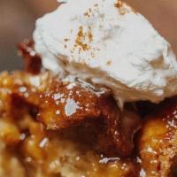 Bread Pudding · Fresh NOLA bread cubed, soaked in cream, topped with house-made whipped cream and drizzled w...