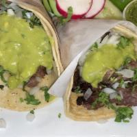 Tacos Al Carbon · Steak or Chicken. Skirt steak or chicken breast flame broiled sliced and folded into soft co...