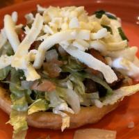 Sopes · Crispy thick cornmeal shell, with your choice of meat. Topped with lettuce, sour cream, shre...