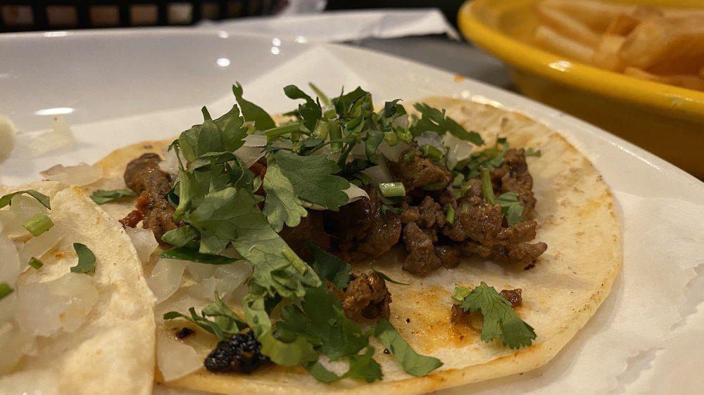 Carne Azada Taco Combo · Three folded soft corn tortillas filled with grilled steak, topped with cilantro & raw onions. Served with beans or rice.