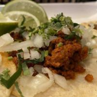Taco Chorizo Combo · Three folded soft corn tortillas filled with chorizo (Mexican sausage) topped with cilantro ...
