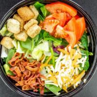 Donks Dinner Salad · A blend of fresh lettuce mixed with diced tomatoes, bacon, onions, cheese and croutons. Serv...