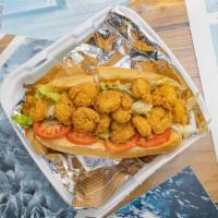 *Fried Shrimp Po Boy · A generous portion of fried shrimp served on a toasted hoagie roll with lettuce, tomatoes, a...