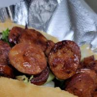 *Andouille Sausage Po Boy · Grilled medallions of andouille sausage served on a toasted hoagie roll with lettuce, tomato...
