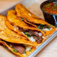 Birria Tacos · Slow cooked beef, corn tortillas dipped in broth, cheese, onion, cilantro, side of broth. Th...